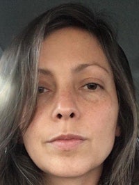 a woman in a car with brown hair and freckles