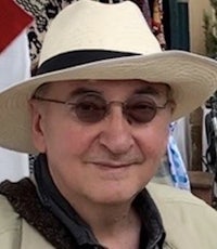 a man wearing a hat and sunglasses